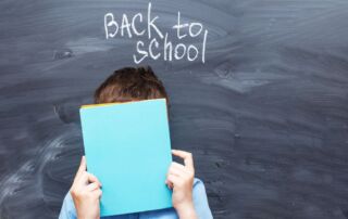 child-boy-covered-his-face-with-a-textbook-