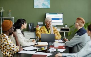 smiling-female-manager-talking-to-young-team-